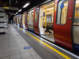 Fototapeta Londyn - A tube train with social distancing measures at Euston Square railway station in London
