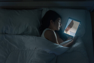 Asain woman VDO calling a boyfriend in a tablet on the bed in the night. She fell asleep