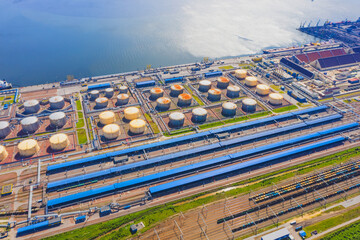 Wall Mural - Huge port with oil tanks for storing liquid fuel on the seashore.