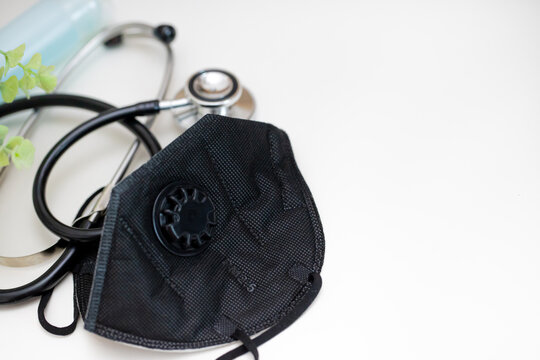 Coronavirus prevention medical surgical black mask pm2.5 and hand sanitizer gel for hand hygiene corona virus protection.With black stethoscope.