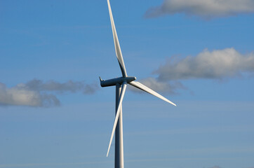 windmill on blue sky background with some clouds