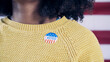 Black woman with I Voted sticker after voting in the 2024 election