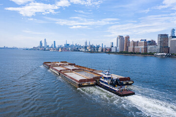 Barging ship with manhattan skyline from Hudson river 