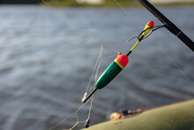Bobber And Tangled Fishing Line. Blurred Water Background.