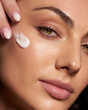 © Артем Жирнов - Close up beauty portrait laughing beautiful half naked woman applying face cream make up health spa fresh skin