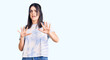 © Krakenimages.com - Young beautiful girl wearing casual t shirt afraid and terrified with fear expression stop gesture with hands, shouting in shock. panic concept.