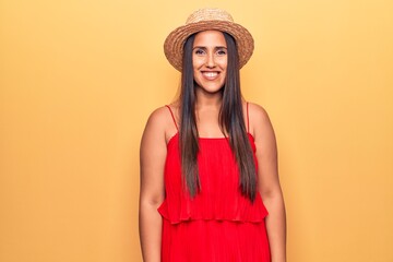 Sticker - Young beautiful brunette woman wearing summer hat and dress looking positive and happy standing and smiling with a confident smile showing teeth