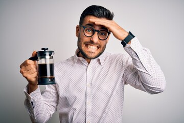 Sticker - Young handsome man making coffee using french press coffeemaker over isolated background stressed with hand on head, shocked with shame and surprise face, angry and frustrated. Fear and upset.