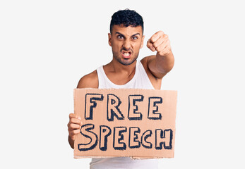 Poster - Young hispanic man holding free speech banner annoyed and frustrated shouting with anger, yelling crazy with anger and hand raised