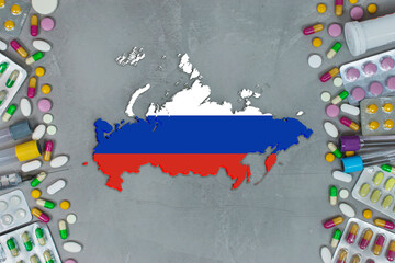 The Russia State began research for treatment and medicine to combat the pandemic outbreak disease coronavirus. Medicine, pills, needles, syringes and Russia map and flag on gray background.