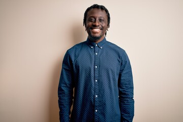 Poster - Young handsome african american man wearing casual shirt standing over white background with a happy and cool smile on face. Lucky person.