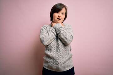 Canvas Print - Young down syndrome woman wearing casual sweater over isolated background shouting and suffocate because painful strangle. Health problem. Asphyxiate and suicide concept.