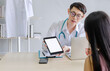 © anuchit2012 - doctor talking with patients by tablet