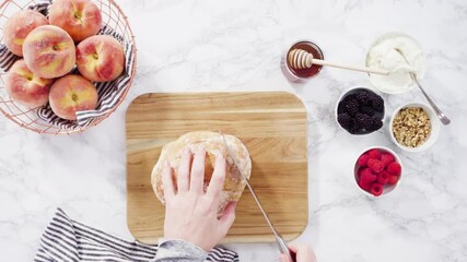 Poster - Flat lay. Step by step. Slicing a loaf of ciabatta bread with a bread knife on a wood cutting board.