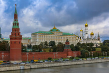 View Of The Red Kremlin Wall, Tower And Golden Onion Domes Of Cathedrals Over The Moskva River In Moscow, Russia