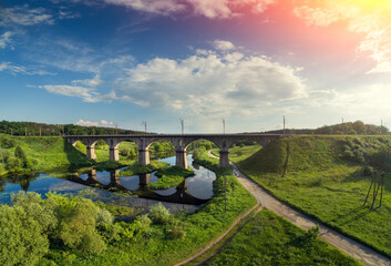 Panoramic view of the Old Arched Stone Railway Viaduct Bridge over the river. City Novograd-Volynsky, Ukraine, Europe