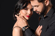 © Pixel-Shot - Young couple wearing stylish accessories on dark background