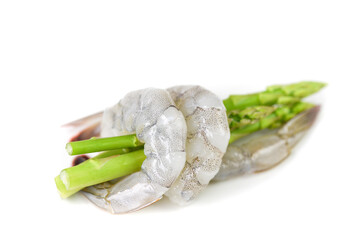 Asparagus Shrimp - Fresh raw shrimps prawns wrapped around green asparagus on white background