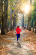 © Microgen - Woman Jogging Outdoors in Park