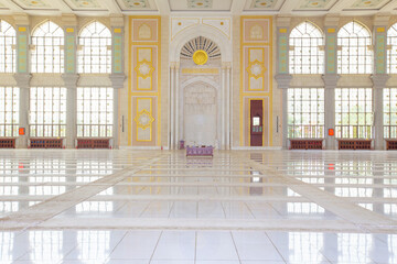 The interior of a mosque, with white marble floor.