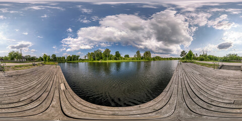 Wall Mural - full seamless spherical hdri panorama 360 degrees  angle view on wooden pier of lake or rivere with beautiful clouds in equirectangular projection, VR content