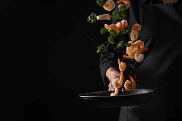 Wall Mural - Professional chef prepares shrimps with greens. Cooking seafood, healthy vegetarian food, and food on a dark background. Horizontal view.