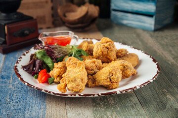 Poster - Crispy deep-fried chicken wings with greens 