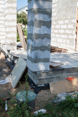 concept of alteration of construction at customer's request. Load-bearing columns made of foam block are taken out of  perimeter of foundation by 10 centimeters to increase space on veranda