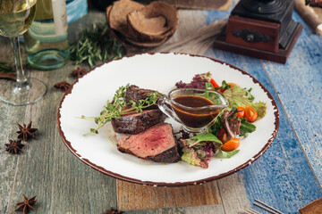 Wall Mural - Tender steak mignon with greens and sauce