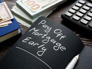 Wall Mural - Pay off mortgage early memo on the black page.