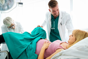 Wall Mural - Pregnant woman with doctor in maternity hospital before childbirth