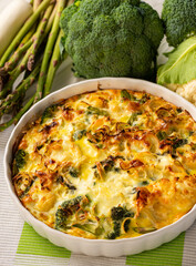 Wall Mural - Broccoli, cauliflower and asparagus casserole with eggs and cheese, keto diet dish.