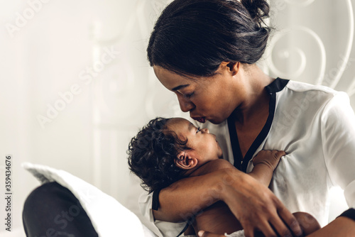 Cuadros en Lienzo Portrait of enjoy happy love family african american mother playing with adorable little african american baby