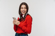 © Drobot Dean - Photo of happy caucasian woman smiling while using cellphone and headphones