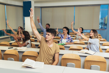 Poster - Group of students raising hands in class on lecture