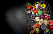 © Andrii - Assortment of fresh fruits and vegetables on dark background. Concept of healthy food. Top view with copy space