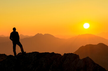 Aufkleber - Happy success winning man standing relaxed on mountain at sunset. Border region of Tyrol, Austria and Allgaeu, Bavaria, Germany.