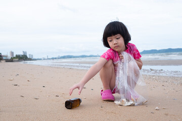 Children pick up trash on the beach, dirty sea
