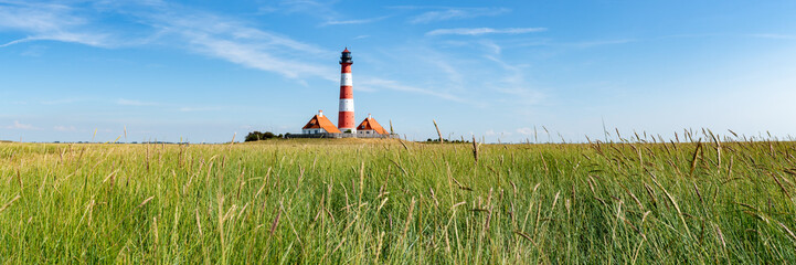 Wall Mural - panoramic view of the salzwiesen at the westerheversand lighthouse, schleswig-holstein, germany