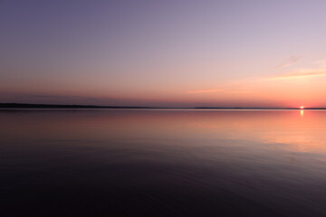 Wall Mural - Tranquility sunset on the lake under the cloudless sky