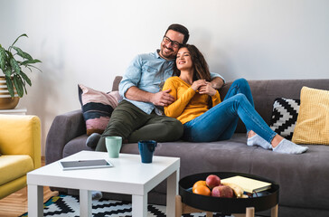 Loving couple embracing on sofa stock photo