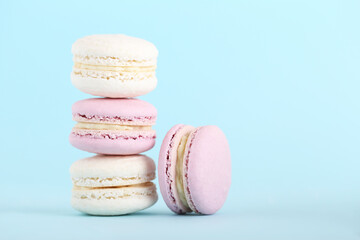 Sticker - Sweet macarons on blue background. Minimalism concept