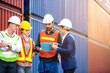 © ftgstudio - Industrial worker working at cargo freight logistic warehouse for import export, foreman team meeting and brainstorm , Import and export business.