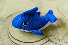 Plush Toy In The Shape Of A Dolphin In The Water For Children.