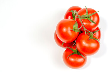 a sprig of red tomatoes is isolated on a white background