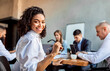 © Prostock-studio - Cheerful African Businesswoman Sitting With Business Partners In Modern Office