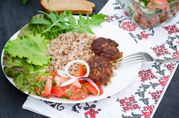 Cutlets with buckwheat porridge and salad. Healthy eating concept. Macro photo. Top view and side view. Erupny plan of the dish.