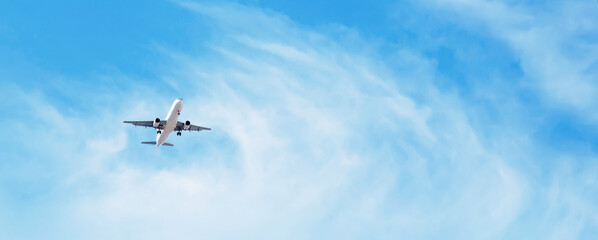 panoramic background with flying plane in blue sky