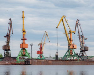 Shipbuilding plant. Crane operation at the shipbuilding, commercial, sea, river, port. Loading, unloading of goods, bulk materials by cranes of the river port (dock).