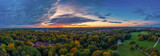 Fototapeta Do pokoju - Impressive sunrise over Munich - drone shot over the Englischer Garten of the bavarian capital as great background pano